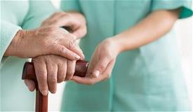 Nurse hold elderly hands