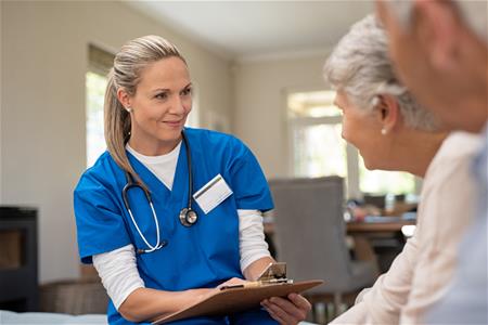 Nurse talking to elderly couple