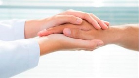 femal-doctor-cupping-patients-hand-for-web