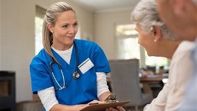Nurse talking to elderly couple