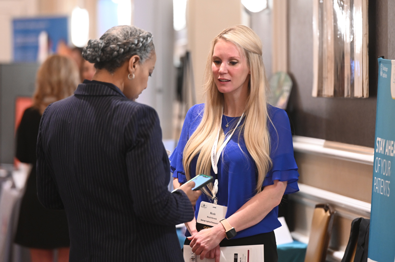 Attendees visit with exhibitors to learn about the latest clinical findings.